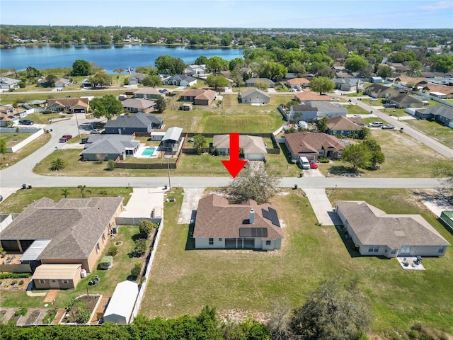 bird's eye view with a residential view and a water view