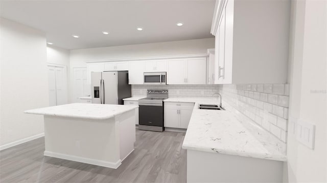 kitchen with a sink, a center island, stainless steel appliances, white cabinets, and decorative backsplash