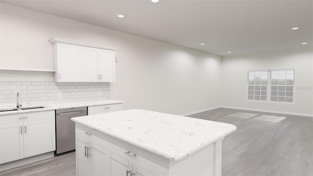 kitchen featuring a sink, a kitchen island, light wood-style floors, decorative backsplash, and dishwasher