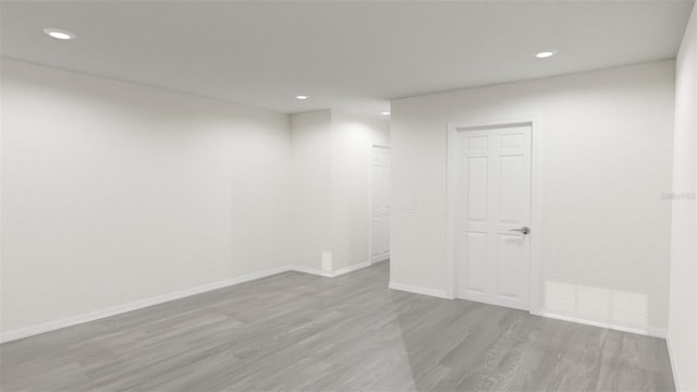 empty room with recessed lighting, baseboards, and wood finished floors