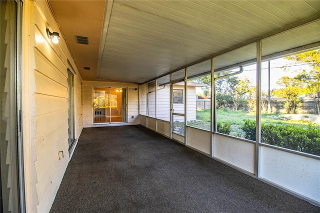 unfurnished sunroom featuring visible vents