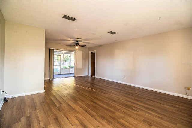 empty room with visible vents, baseboards, wood finished floors, and a ceiling fan