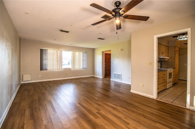 interior space featuring baseboards, visible vents, and dark wood-style flooring