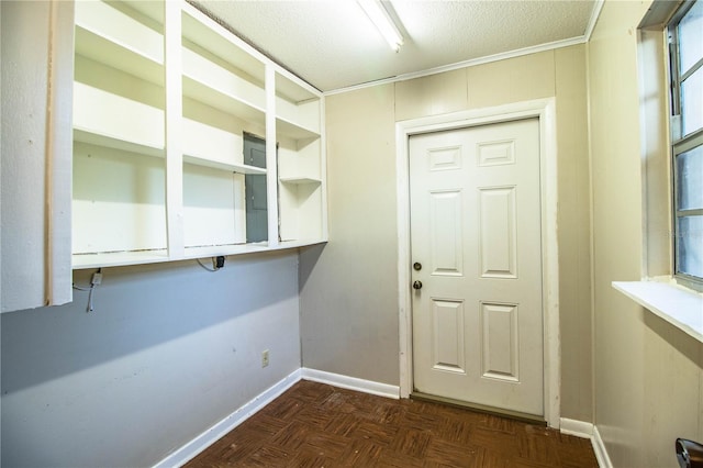 interior space featuring a textured ceiling and baseboards