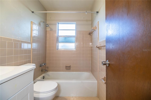 full bathroom with toilet, tile walls, vanity, and bathtub / shower combination