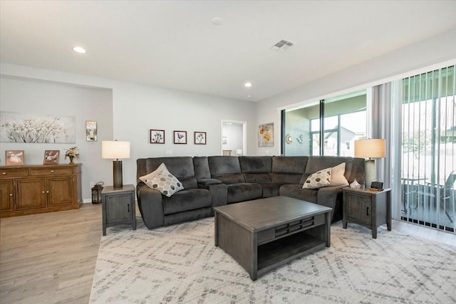 living room featuring visible vents, recessed lighting, and light wood-style floors