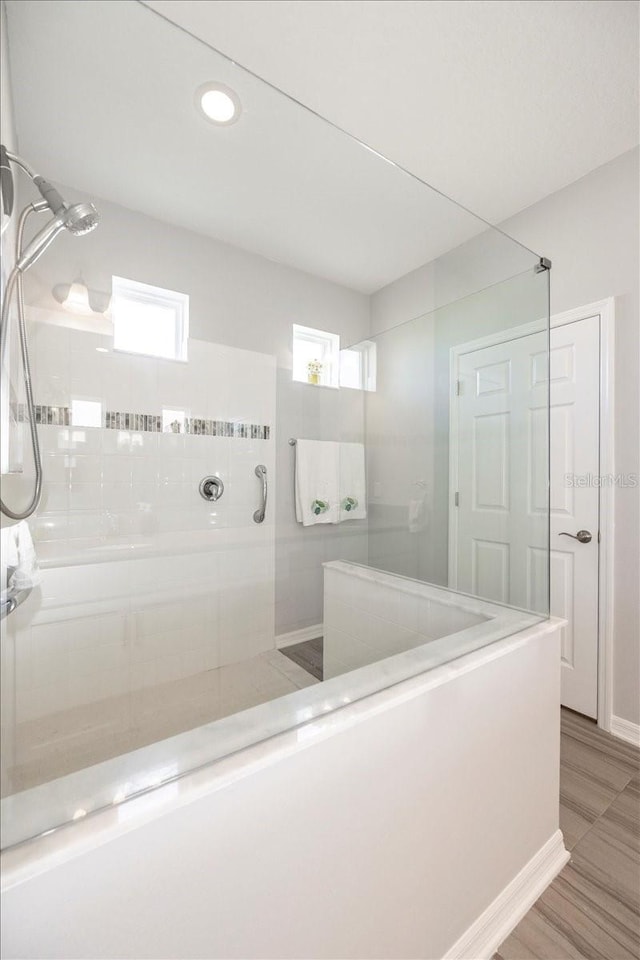 bathroom featuring baseboards and walk in shower