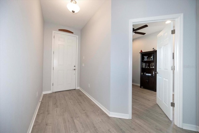 hallway with baseboards and light wood finished floors