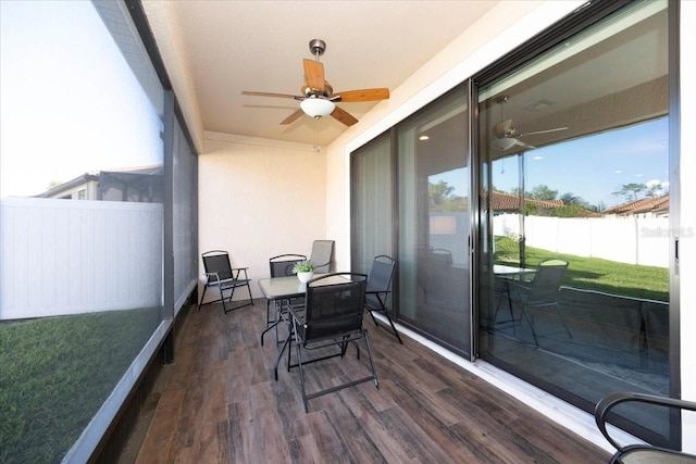 sunroom / solarium with a ceiling fan