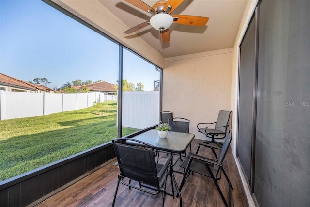 sunroom featuring ceiling fan