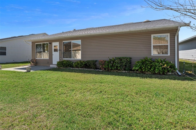 ranch-style house featuring a front lawn and a patio area