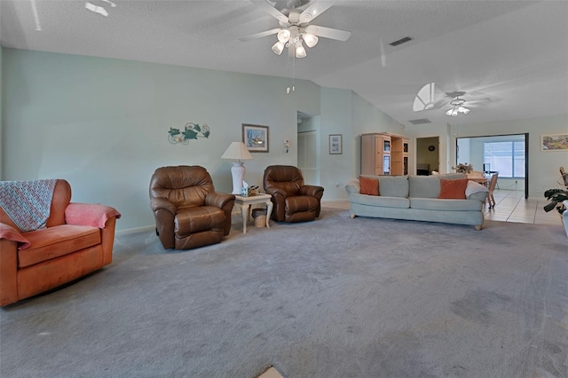 carpeted living room featuring visible vents, a ceiling fan, a textured ceiling, baseboards, and vaulted ceiling