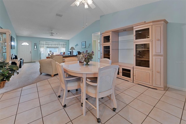 dining area with light tile patterned floors, lofted ceiling, beverage cooler, and ceiling fan