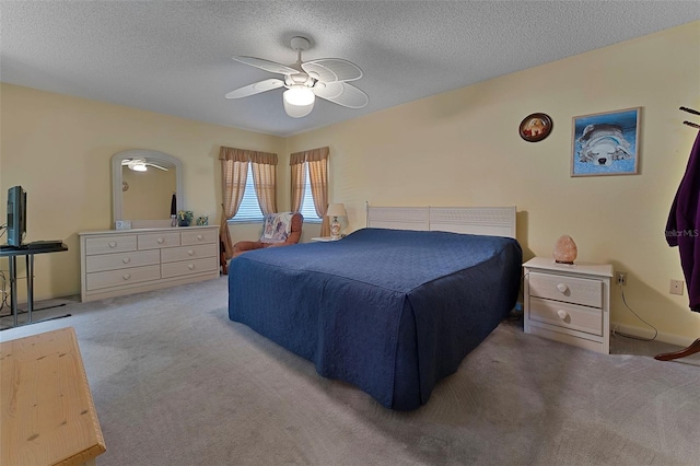 bedroom with carpet floors, a textured ceiling, and ceiling fan