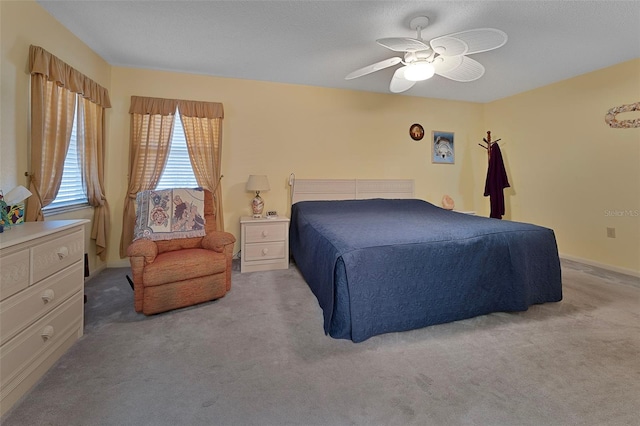 bedroom featuring light carpet and a ceiling fan