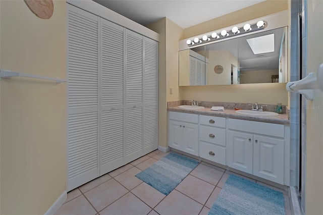 full bath featuring a sink, a closet, double vanity, and tile patterned flooring