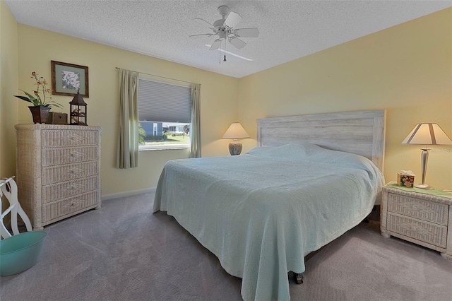 carpeted bedroom with baseboards, a textured ceiling, and ceiling fan