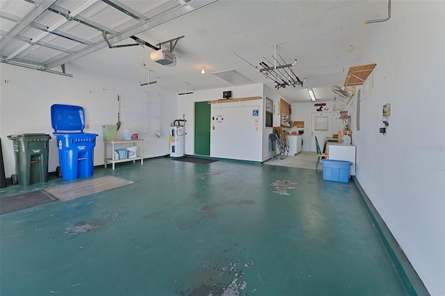 garage with a garage door opener and electric water heater