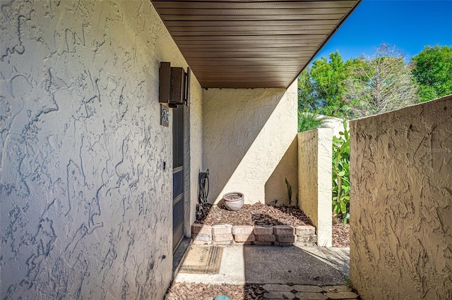 exterior space with stucco siding and fence