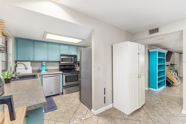 kitchen featuring visible vents, a sink, appliances with stainless steel finishes, light countertops, and light tile patterned floors