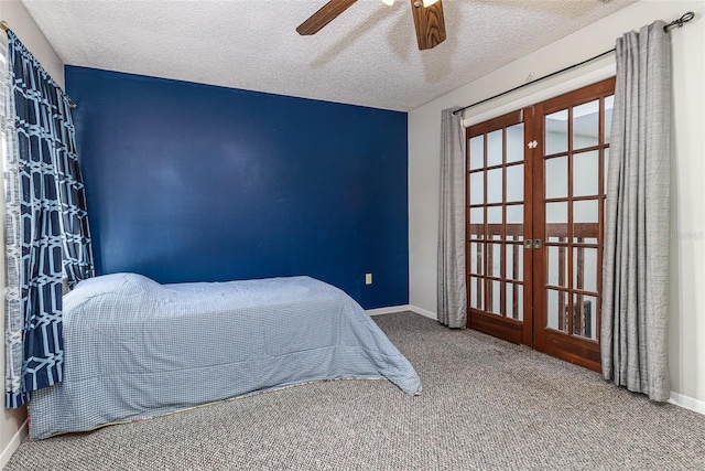 carpeted bedroom featuring french doors, a textured ceiling, and baseboards