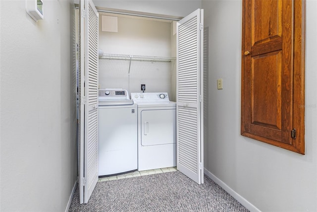 washroom with baseboards, light carpet, independent washer and dryer, and laundry area