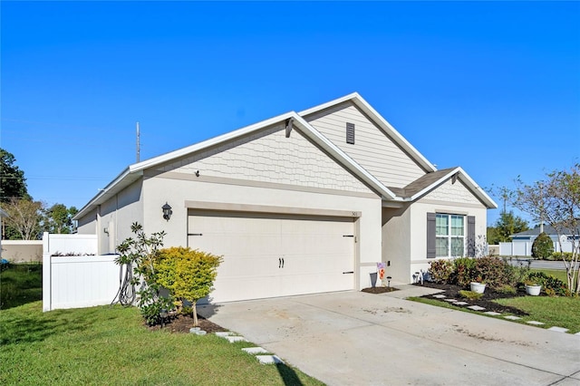 view of front of home featuring stucco siding, fence, concrete driveway, a front yard, and an attached garage