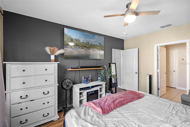 bedroom featuring a ceiling fan, baseboards, and visible vents