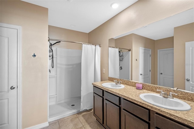 bathroom featuring a sink, a shower with shower curtain, double vanity, and tile patterned flooring