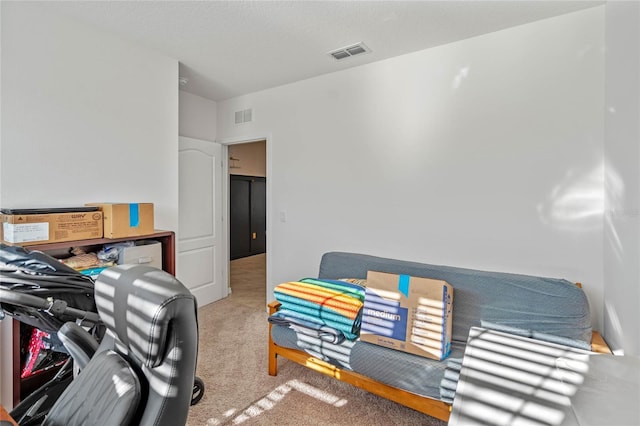 bedroom with visible vents and carpet flooring