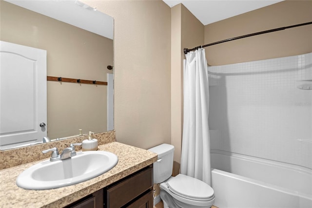 bathroom with vanity, shower / tub combo, and toilet