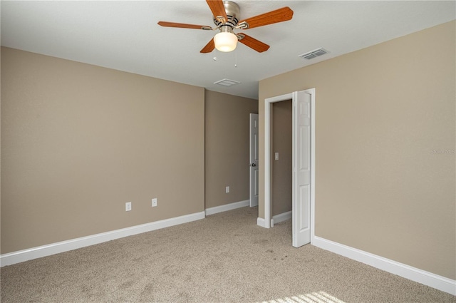 unfurnished bedroom featuring a ceiling fan, light colored carpet, visible vents, and baseboards