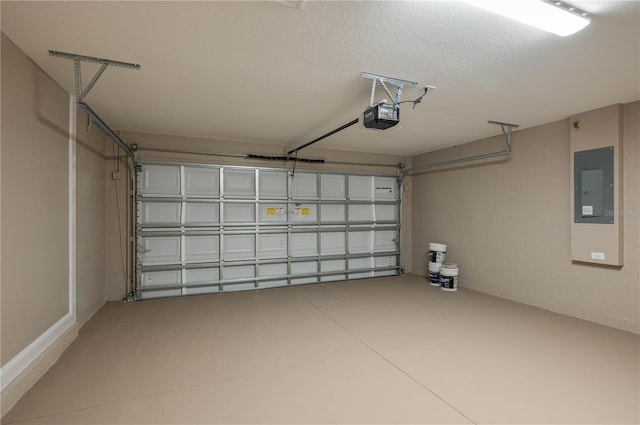 garage with concrete block wall, electric panel, and a garage door opener