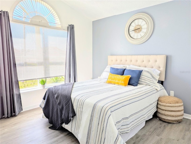 bedroom with wood finished floors and baseboards