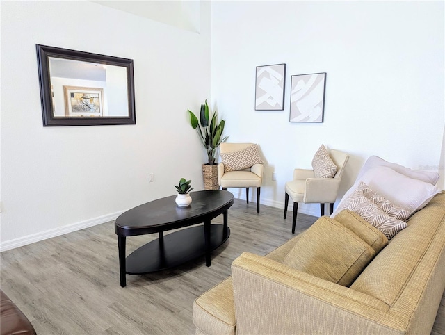 sitting room with baseboards and light wood-style floors