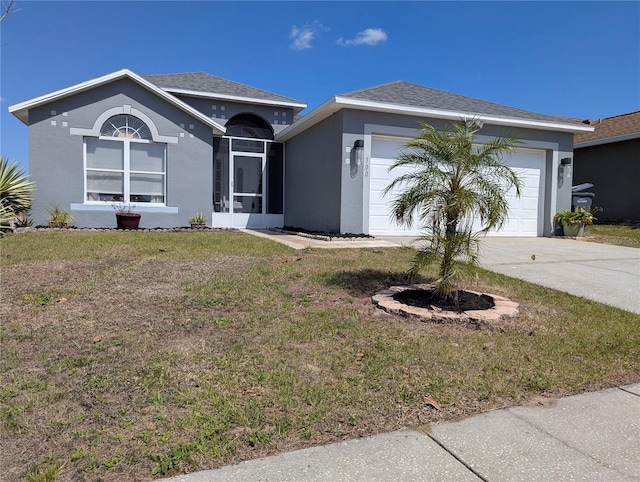 ranch-style home with stucco siding, driveway, a garage, and a front lawn