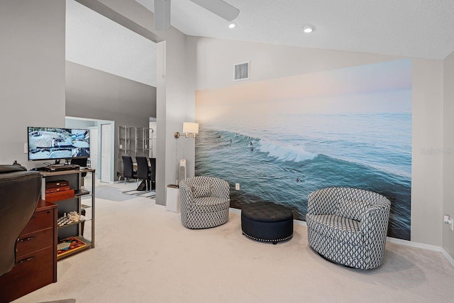 living area with visible vents, carpet floors, a ceiling fan, and vaulted ceiling