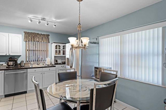 dining area with light tile patterned floors and a chandelier