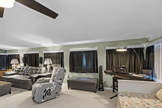 living room with baseboards, carpet floors, and a textured ceiling