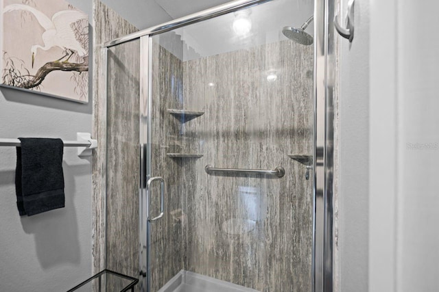 full bath featuring a shower stall