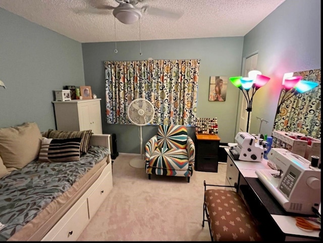 bedroom with ceiling fan, a textured ceiling, and carpet