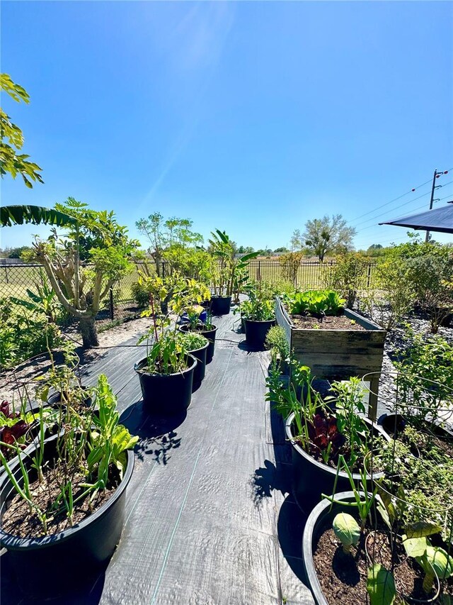 view of patio / terrace featuring a vegetable garden and fence