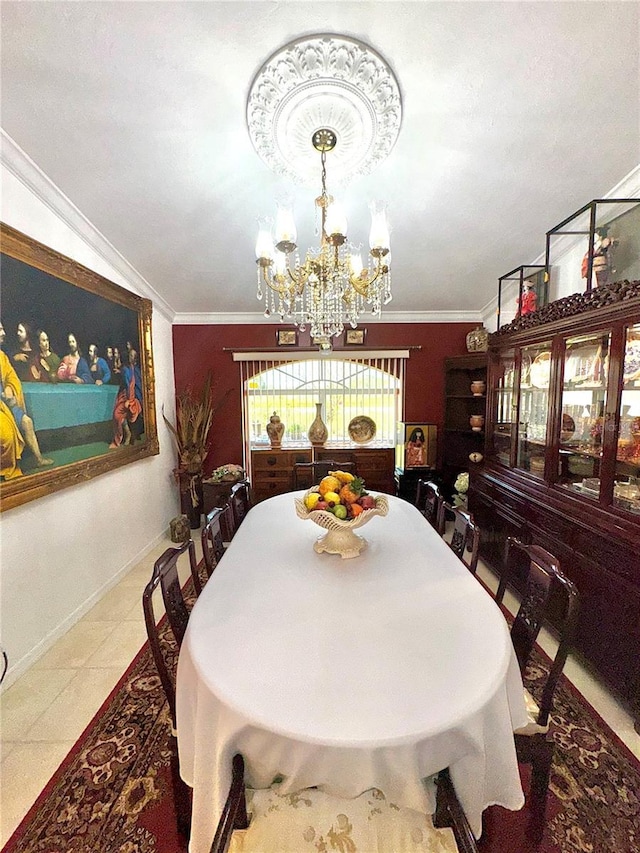 dining space featuring a chandelier, tile patterned flooring, baseboards, and ornamental molding