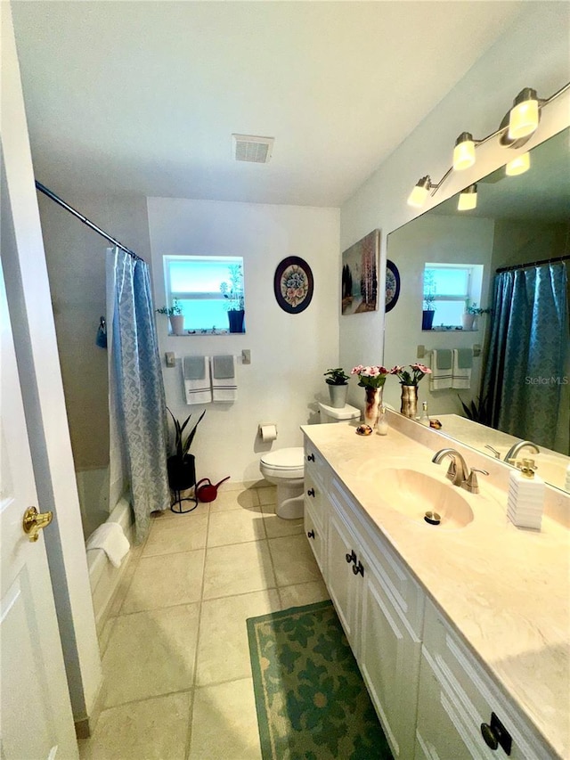 bathroom with vanity, visible vents, tile patterned flooring, curtained shower, and toilet