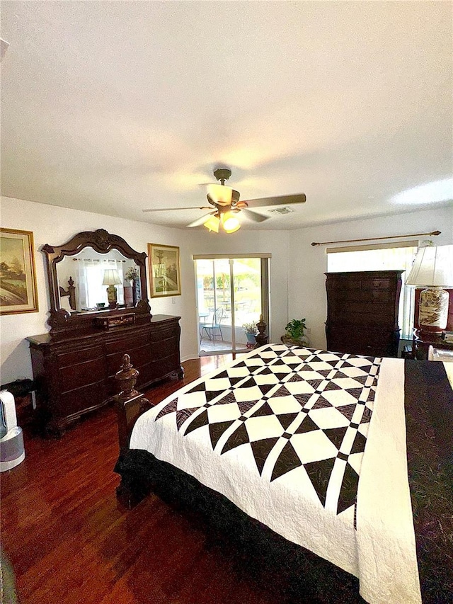 bedroom with visible vents, wood finished floors, a ceiling fan, and access to outside