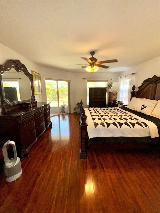 bedroom featuring access to outside, wood finished floors, and ceiling fan