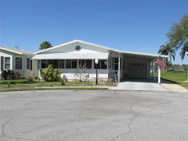 view of front of property featuring a garage, driveway, and a front lawn