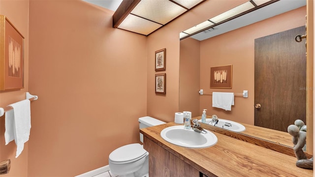 bathroom with vanity, toilet, and visible vents