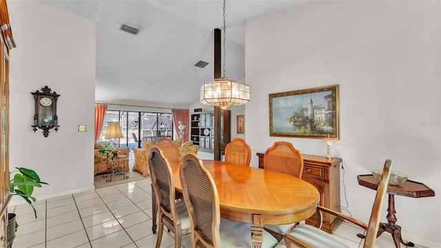 dining area featuring light tile patterned floors, baseboards, visible vents, lofted ceiling, and a chandelier