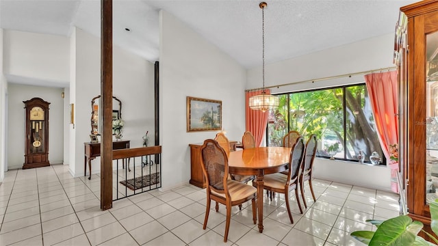 dining room with light tile patterned floors, an inviting chandelier, a textured ceiling, and lofted ceiling